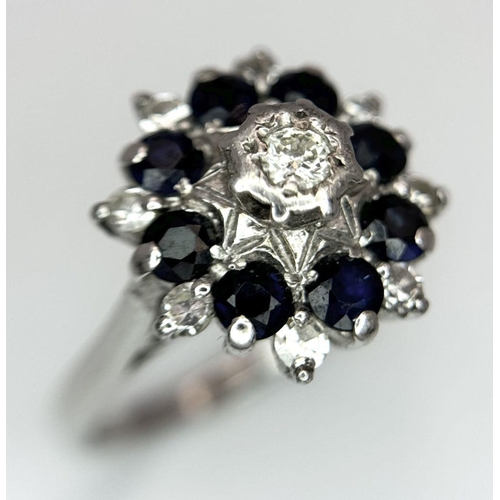 74 - AN 18K WHITE GOLD DIAMOND & SAPPHIRE CLUSTER RING. 5.2G IN WEIGHT. SIZE J. Ref: SC 6094