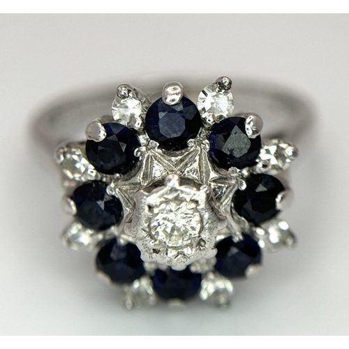 74 - AN 18K WHITE GOLD DIAMOND & SAPPHIRE CLUSTER RING. 5.2G IN WEIGHT. SIZE J. Ref: SC 6094