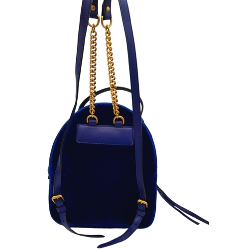 624 - A Gucci Marmont Blue Velvet Backpack. Gold tone hardware. Blue leather straps. Pink textile interior... 