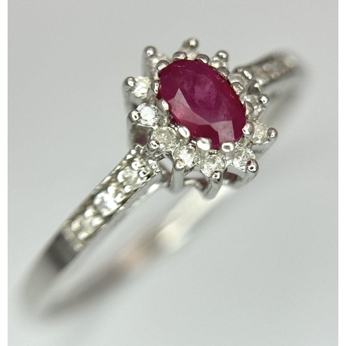 1335 - A 9K WHITE GOLD DIAMOND AND RUBY RING. 2G. SIZE T. SC5034