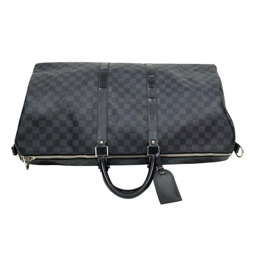 645 - A Louis Vuitton Blue and Black Damier Keepall 55 Bag. Blue and black Damier canvas exterior with bla... 