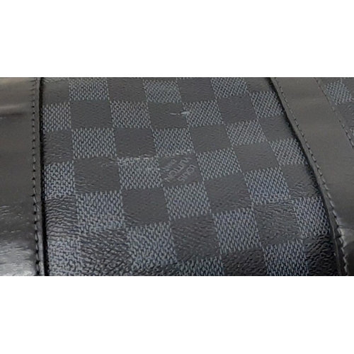 645 - A Louis Vuitton Blue and Black Damier Keepall 55 Bag. Blue and black Damier canvas exterior with bla... 