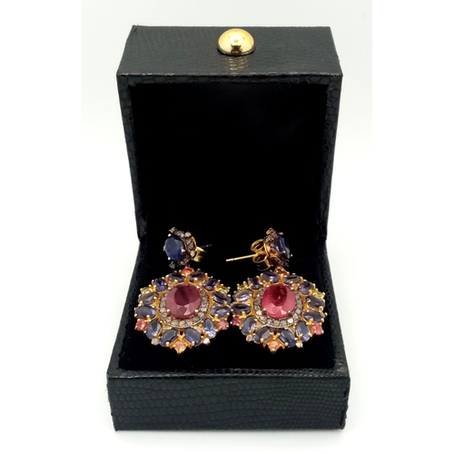 373 - A pair of 925 Silver Ruby and Kyanite Earrings, featuring a central ruby surrounded by kyanite stone... 