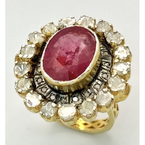 415 - A 10.2ct Ruby Gemstone Ring with a halo of 1ct round diamonds and 2ct flat Polki diamonds, set in 92... 