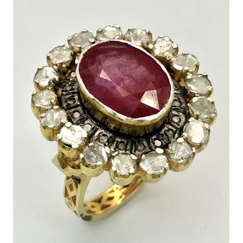 415 - A 10.2ct Ruby Gemstone Ring with a halo of 1ct round diamonds and 2ct flat Polki diamonds, set in 92... 