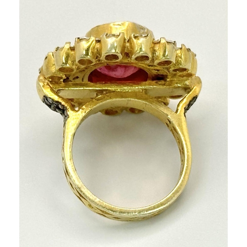 415 - A 10.2ct Ruby Gemstone Ring with a halo of 1ct round diamonds and 2ct flat Polki diamonds, set in 92... 