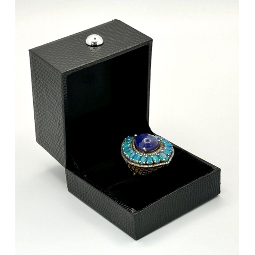 436 - A 925 Silver Tanzanite and Blue Opal Ring, in a tear drop shape. Featuring approximately 10.5cts of ... 