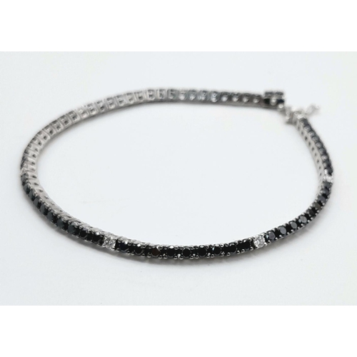 47 - A 18K WHITE GOLD BLACK & WHITE DIAMOND TENNIS BRACELET 2.10CT 7.9G , 17.6CM IN LENGTH. Ref: SC 6076