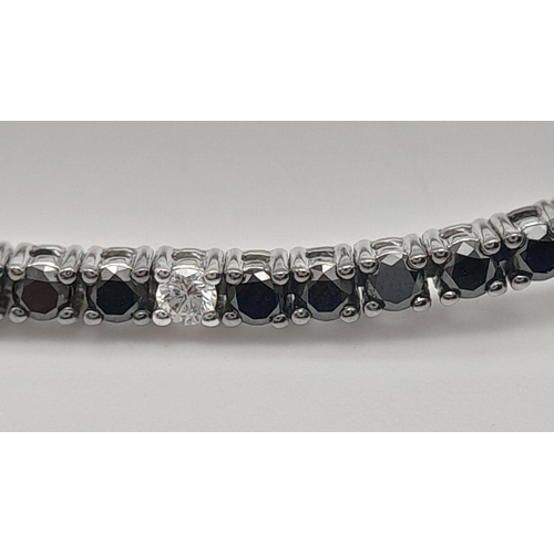 47 - A 18K WHITE GOLD BLACK & WHITE DIAMOND TENNIS BRACELET 2.10CT 7.9G , 17.6CM IN LENGTH. Ref: SC 6076