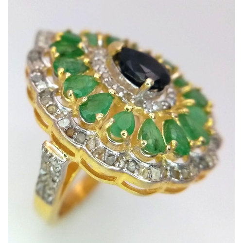 513 - An Emerald and Sapphire Ring, featuring approximately 1.5ct emeralds and 2.65cts of diamonds, set in... 