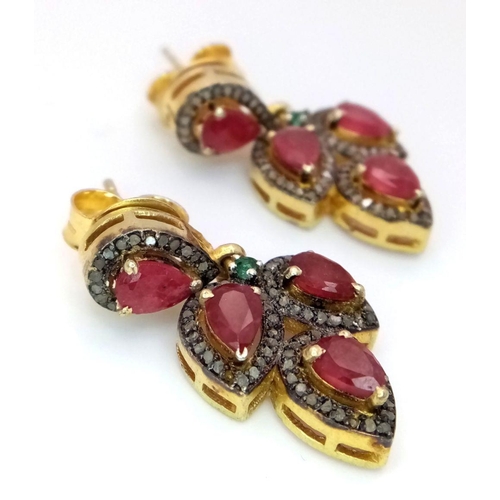 526 - A Pair of 925 Silver Ruby and Diamond Earrings, in a three teardrop-shaped design. Featuring approxi... 