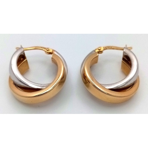 233 - A STYLISH PAIR OF 14K YELLOW AND WHITE GOLD EARRINGS .  4.1gms