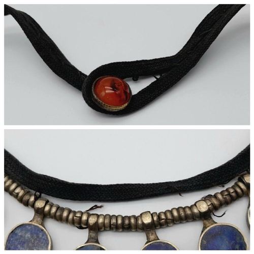 618 - A Vintage Tribal-Esque Lapis Lazuli Necklace. On white metal and textile. 47cm.