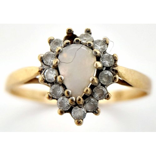 127 - A 9K GOLD RING WITH CENTRAL OPAL STONE SURROUNDED BY DIAMONDS (1 stone missing)  1.6gms    size P