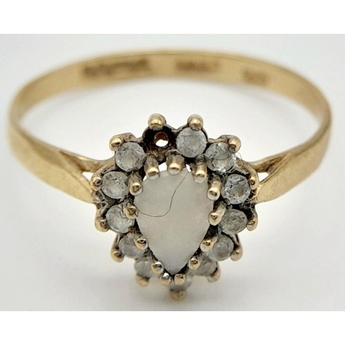 127 - A 9K GOLD RING WITH CENTRAL OPAL STONE SURROUNDED BY DIAMONDS (1 stone missing)  1.6gms    size P