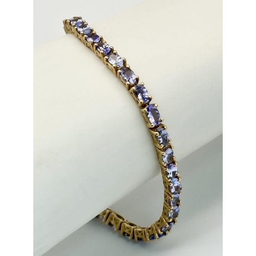 585 - A Yellow Gold Gilt Sterling Silver Tanzanite Set Tennis Bracelet-21cm Length. Set with Thirty-Nine 5... 