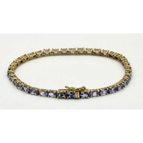 585 - A Yellow Gold Gilt Sterling Silver Tanzanite Set Tennis Bracelet-21cm Length. Set with Thirty-Nine 5... 