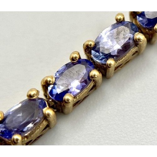 585 - A Yellow Gold Gilt Sterling Silver Tanzanite Set Tennis Bracelet-21cm Length. Set with Thirty-Nine 5... 