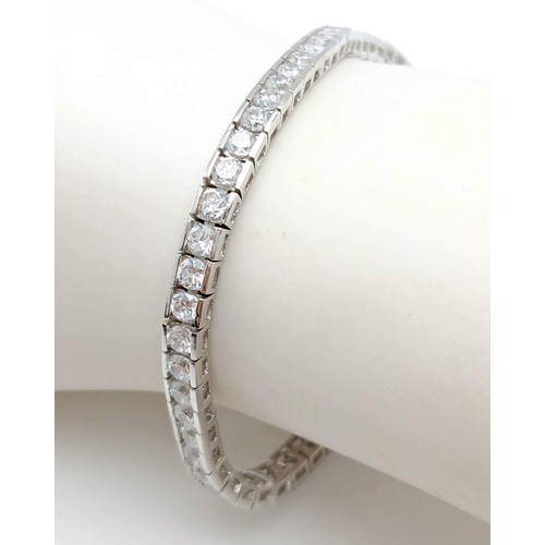 879 - A Sterling Silver Cubic Zirconia Set Tennis Bracelet. 19cm Length, 4mm Width. Gross Weight 12.19 Gra... 