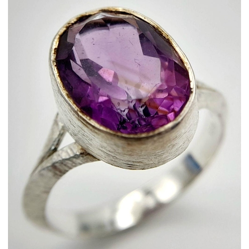 886 - A Sterling Silver Bark Pattern Amethyst Set Ring Size U. Set with a 1.4cm Long Faceted Amethyst the ... 