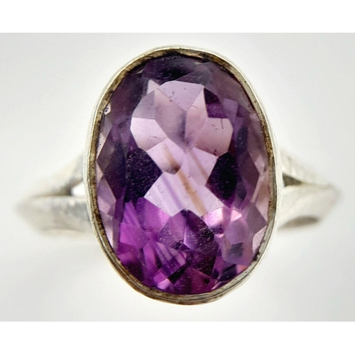 886 - A Sterling Silver Bark Pattern Amethyst Set Ring Size U. Set with a 1.4cm Long Faceted Amethyst the ... 