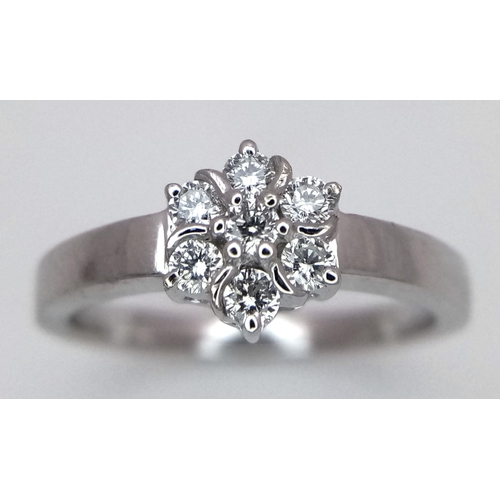 242 - AN 18K WHITE GOLD DIAMOND CLUSTER RING. 0.20CTW. 3.6G. SIZE L. SPEN6002