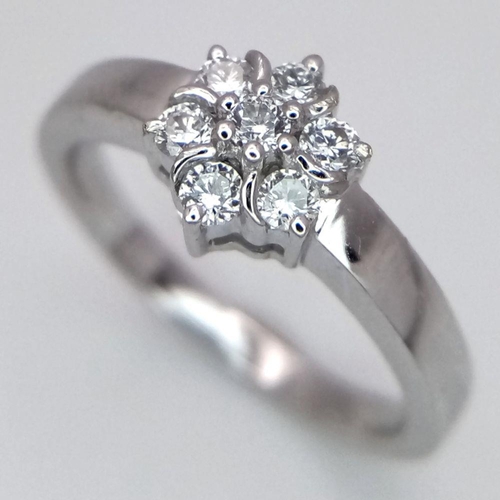 242 - AN 18K WHITE GOLD DIAMOND CLUSTER RING. 0.20CTW. 3.6G. SIZE L. SPEN6002