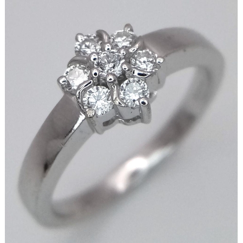 242 - AN 18K WHITE GOLD DIAMOND CLUSTER RING. 0.20CTW. 3.6G. SIZE L. SPEN6002