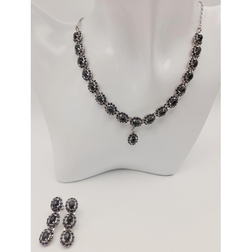 1256 - A Blue Sapphire Silver Choker Necklace with Matching Drop Earrings. Both set in 925 sterling silver.... 