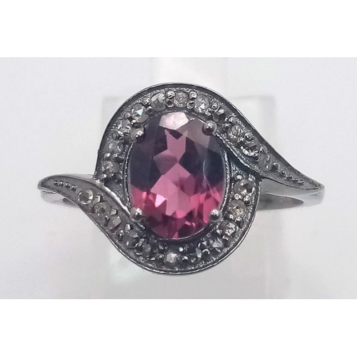 1899 - A Garnet and Diamond Ring set  in 925 Silver with a Black Rhodium coating. Oval cut Garnet- 0.80ct. ... 