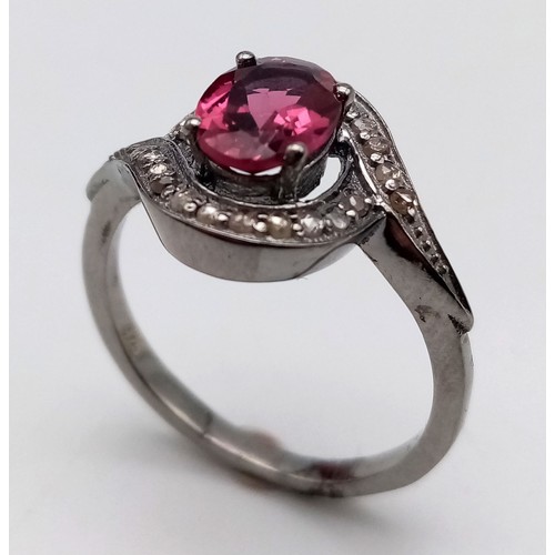 1899 - A Garnet and Diamond Ring set  in 925 Silver with a Black Rhodium coating. Oval cut Garnet- 0.80ct. ... 