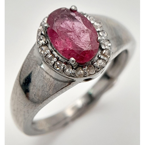 1816 - A Rhodolite Garnet and Diamond Ring, Oval cut rhodolite with rose cut diamond surround. Set in 925 S... 