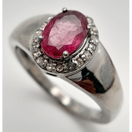 1816 - A Rhodolite Garnet and Diamond Ring, Oval cut rhodolite with rose cut diamond surround. Set in 925 S... 