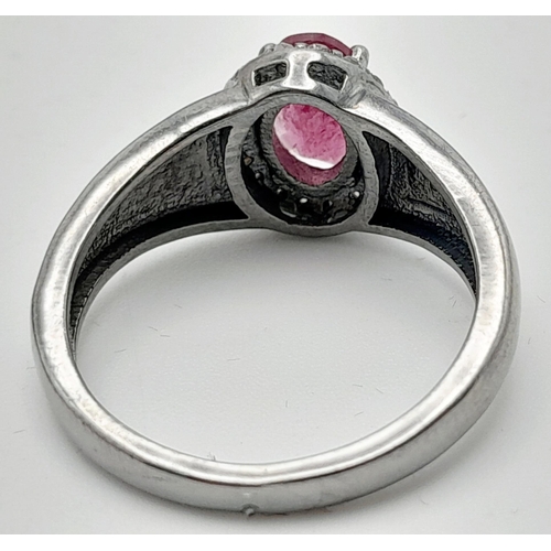 1816 - A Rhodolite Garnet and Diamond Ring, Oval cut rhodolite with rose cut diamond surround. Set in 925 S... 