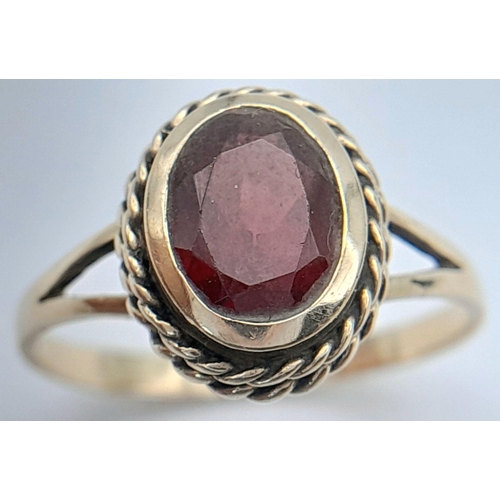 175 - Attractive 9 carat GOLD and GARNET RING.The Garnet beautifully oval cut and Mounted to top with Gold... 