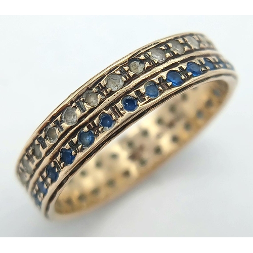 203 - Attractive and unusual 9 carat GOLD DOUBLE RING. Set with twin rows of blue and clear gemstones. Com... 