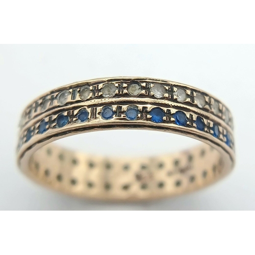 203 - Attractive and unusual 9 carat GOLD DOUBLE RING. Set with twin rows of blue and clear gemstones. Com... 