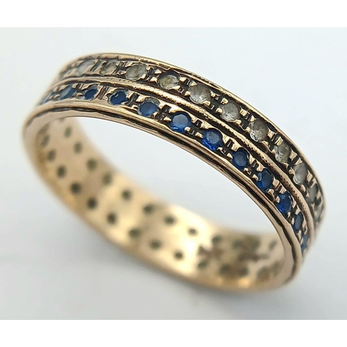 203 - Attractive and unusual 9 carat GOLD DOUBLE RING. Set with twin rows of blue and clear gemstones. Com... 