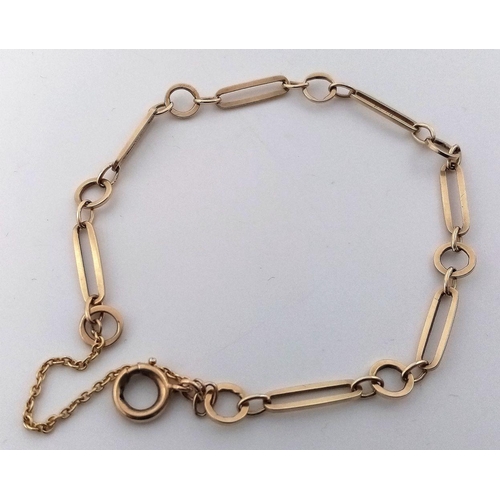 28 - A beautiful 9 carat GOLD BRACELET complete with GOLD safety chain. Having large circular and elongat... 