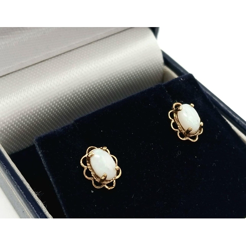 294 - Classic pair of 9 carat GOLD and WHITE FIRE OPAL EARRINGS. Stud style with looped GOLD SURROUND. Com... 