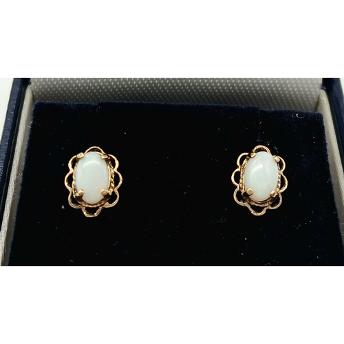 294 - Classic pair of 9 carat GOLD and WHITE FIRE OPAL EARRINGS. Stud style with looped GOLD SURROUND. Com... 