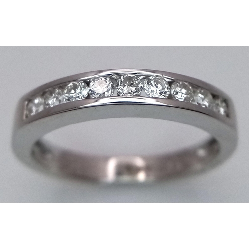 375 - AN 18K WHITE GOLD DIAMOND HALF ETERNITY RING. 0.25CTW. 2.5G. SIZE I. JR4