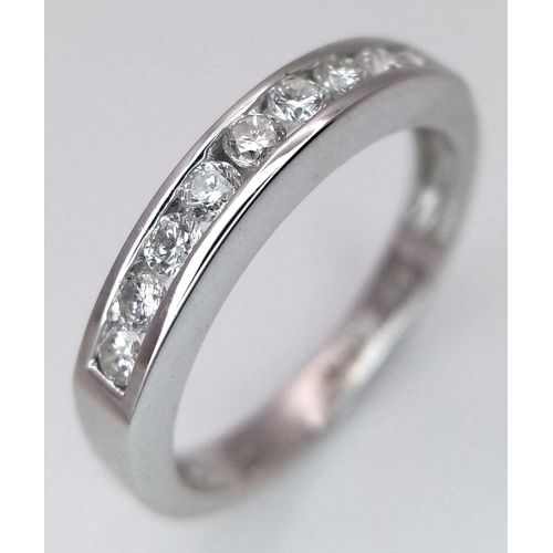 375 - AN 18K WHITE GOLD DIAMOND HALF ETERNITY RING. 0.25CTW. 2.5G. SIZE I. JR4