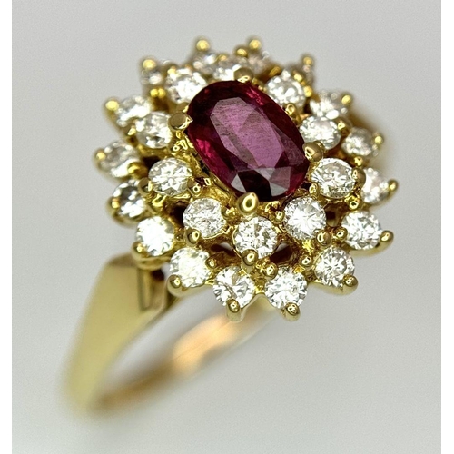 423 - AN 18K YELLOW GOLD DIAMOND AND RUBY CLUSTER RING - 0.40CTW DIAMONDS AND 0.50CT OVAL RUBY. 4.7G. SIZE... 