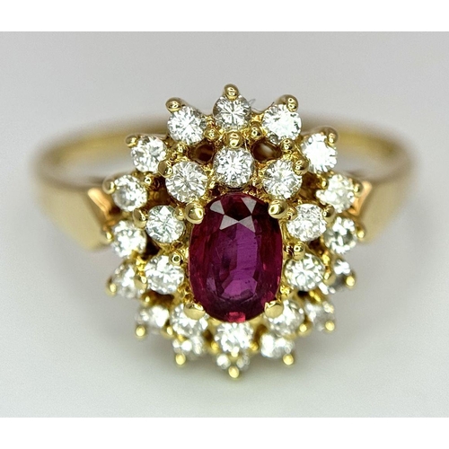 423 - AN 18K YELLOW GOLD DIAMOND AND RUBY CLUSTER RING - 0.40CTW DIAMONDS AND 0.50CT OVAL RUBY. 4.7G. SIZE... 