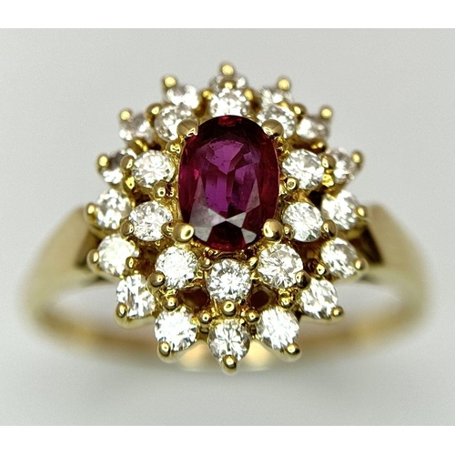 423 - AN 18K YELLOW GOLD DIAMOND AND RUBY CLUSTER RING - 0.40CTW DIAMONDS AND 0.50CT OVAL RUBY. 4.7G. SIZE... 