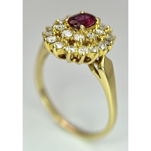 423 - AN 18K YELLOW GOLD DIAMOND AND RUBY CLUSTER RING - 0.40CTW DIAMONDS AND 0.50CT OVAL RUBY. 4.7G. SIZE... 