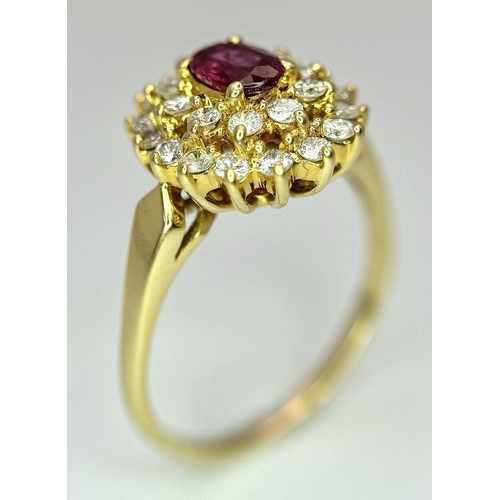 423 - AN 18K YELLOW GOLD DIAMOND AND RUBY CLUSTER RING - 0.40CTW DIAMONDS AND 0.50CT OVAL RUBY. 4.7G. SIZE... 