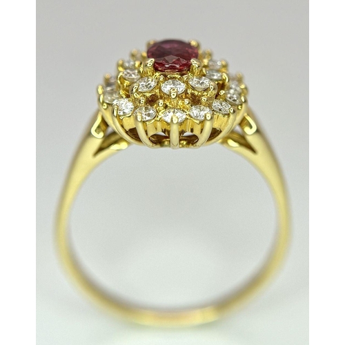 423 - AN 18K YELLOW GOLD DIAMOND AND RUBY CLUSTER RING - 0.40CTW DIAMONDS AND 0.50CT OVAL RUBY. 4.7G. SIZE... 