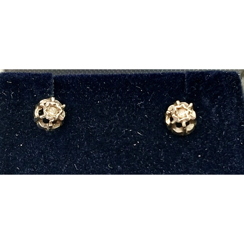 434 - Delicate pair of DIAMOND STUD EARRINGS. Set in 9 carat GOLD and complete with jewellers earring box.... 